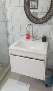 a bathroom with a white sink and a mirror at Lifegate Guesthouse in Johannesburg