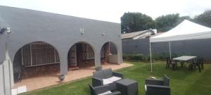 a patio with a table and a white tent at Lifegate Guesthouse in Johannesburg