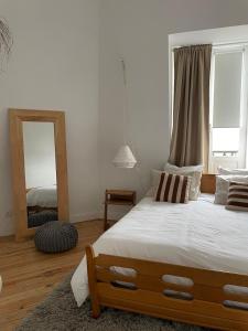 a bedroom with a large bed and a mirror at Halluin Marthe Nollet in Halluin
