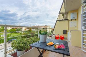 a balcony with a table with food on it at La casa di Plinio in Infernetto