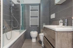 a bathroom with a sink and a toilet and a shower at La casa di Plinio in Infernetto +6 photos