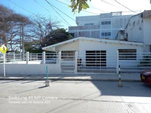 a white building on the side of a street at Hotel H&H in Cartagena de Indias