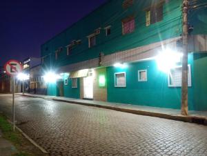 een lege straat 's nachts met lichten op een gebouw bij Hotel Car in Rio Grande