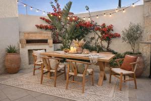 a wooden table and chairs on a patio with a fireplace at Katoi traditional house in Éxo Khóra