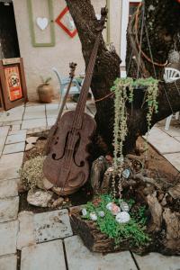 a guitar is hanging from a tree in a garden at Gegund Guest Accomodation in Parys