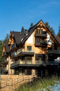 ein großes Haus mit einem Gameradach in der Unterkunft Jaszczurówka 33 Aparthotel & SPA in Zakopane
