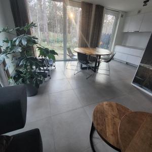 a room with tables and chairs and a large window at White Box in Gierle +38 photos