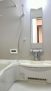 a white bathroom with a sink and a mirror at 京旅别莊 in Kyoto +26 photos