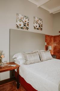 a bedroom with a bed with two paintings on the wall at Gegund Guest Accomodation in Parys +32 photos