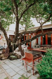 a patio with a tree and a table and chairs at Gegund Guest Accomodation in Parys