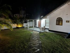 a backyard at night with a house with a light at Seliya Villa Retreat in Balapitiya