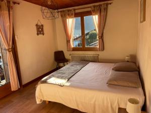 a bedroom with a large bed with a window at Piste B in Morzine