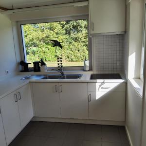 a kitchen with a sink and a window at Kromven in Merksplas +53 photos
