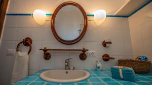 a bathroom with a sink and a mirror at Casa Cielo Mare in Costa Paradiso +41 photos