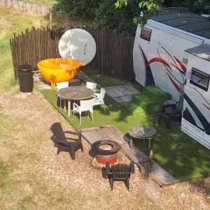 an aerial view of a backyard with a grill and tables and chairs at Kromven On Wheels in Merksplas