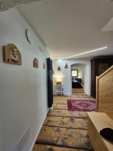 a hallway with white walls and wooden floors at NEW Locanda da Raimondo - das Knarren der Zeit in Tarvisio