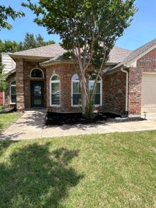 a brick house with a tree in the yard at Rockwall Harbor Retreat in Rockwall
