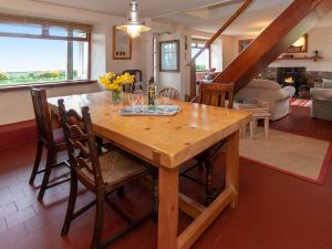 a wooden table in a room with a dining room at Rogeston Mount - Cottage in Nolton