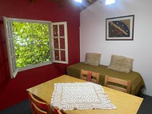 a room with two tables and a window at Felicidades in Rosario +23 photos