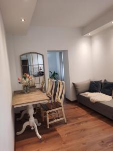 a living room with a table and a couch at Cozy Zdrój in Lądek-Zdrój