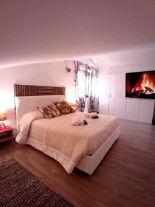 a bedroom with a large bed and a fireplace at La Dimora di Deborah in Montecatini Terme