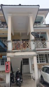 a building with two motorcycles parked in front of it at el-yusra homestay in Bayan Lepas