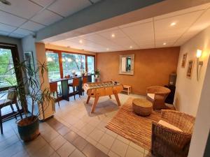 a living room with a table and chairs at Hotel Alicia Auray Le Bono in Le Bono