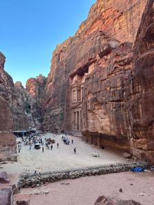 a group of people standing in front of a canyon at Nadina Bedouin home in Petra