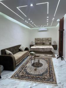 a bedroom with a bed and a couch and a table at Nadina Bedouin home in Petra