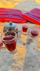 two cups of tea sitting on top of a table at Nadina Bedouin home in Petra
