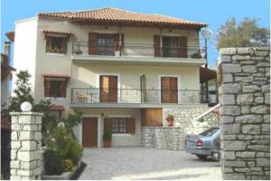 a large house with a car parked in front of it at Studios EYTYXIA-3 in Kalavrita