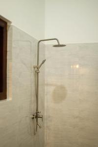 a shower with a shower head in a bathroom at Legacy Weligama - 8 min to Weligama Beach in Weligama +35 photos