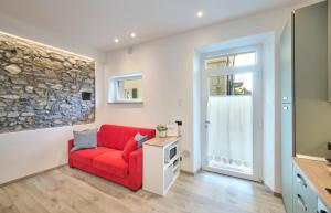 a living room with a red couch and a tv at La cà del Pin in Lierna