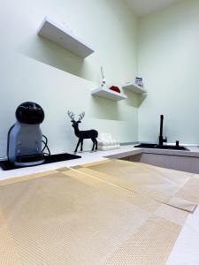 a room with a statue of a deer on the floor at La Chicca di Ameli in San Severo