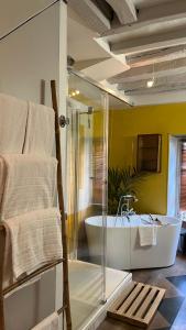 a bathroom with a tub and a glass shower at Le 66 in Paris