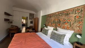a bedroom with a bed with a large tapestry on the wall at Le 66 in Paris
