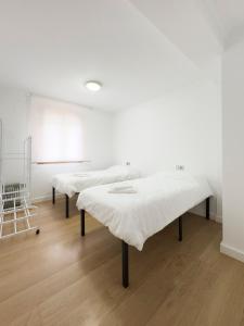 En eller flere senge i et værelse på Apartamento Nayara