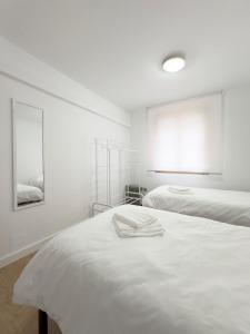 En eller flere senge i et værelse på Apartamento Nayara