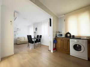 a living room with a table and a washing machine at Apartamento Nayara in Alcañiz
