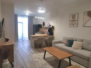 a living room with a couch and a table at River Apartman 1 in Odorheiu Secuiesc