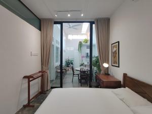 a bedroom with a bed and a dining room with a table at Zen Retreat KL in Kuala Lumpur