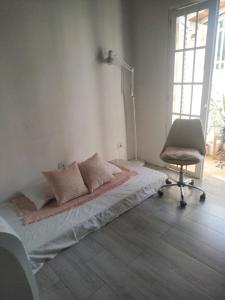 a bedroom with a bed and a chair in it at Casa das Plantas in Piraju +11 photos