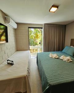 En eller flere senge i et værelse på Pousada Ponta de Areia