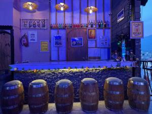 a bar with a row of wine barrels at Hotel MM Inn in Rishīkesh