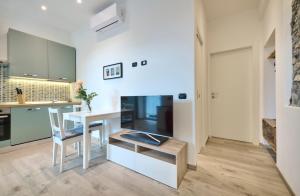 a kitchen with a table and a dining room at La cà del Pin in Lierna +5 photos