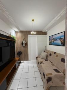 un soggiorno con divano e TV a schermo piatto di Apto Recife Aurora Mar e Rio a Recife