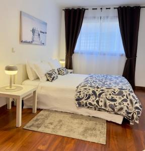 a bedroom with a bed and a window at BARRAMARES 3 in Furadouro