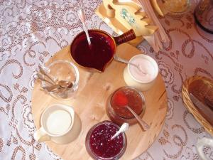 a wooden cutting board with jam and drinks on a table at Wildberry North in St. Anthony