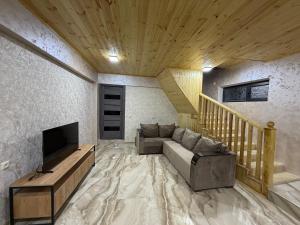 a living room with a couch and a television at Remember Me B&B in Dilijan