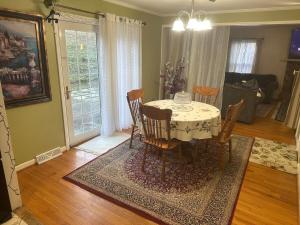 a dining room with a table and chairs in a living room at Honey Home in Danville +40 photos